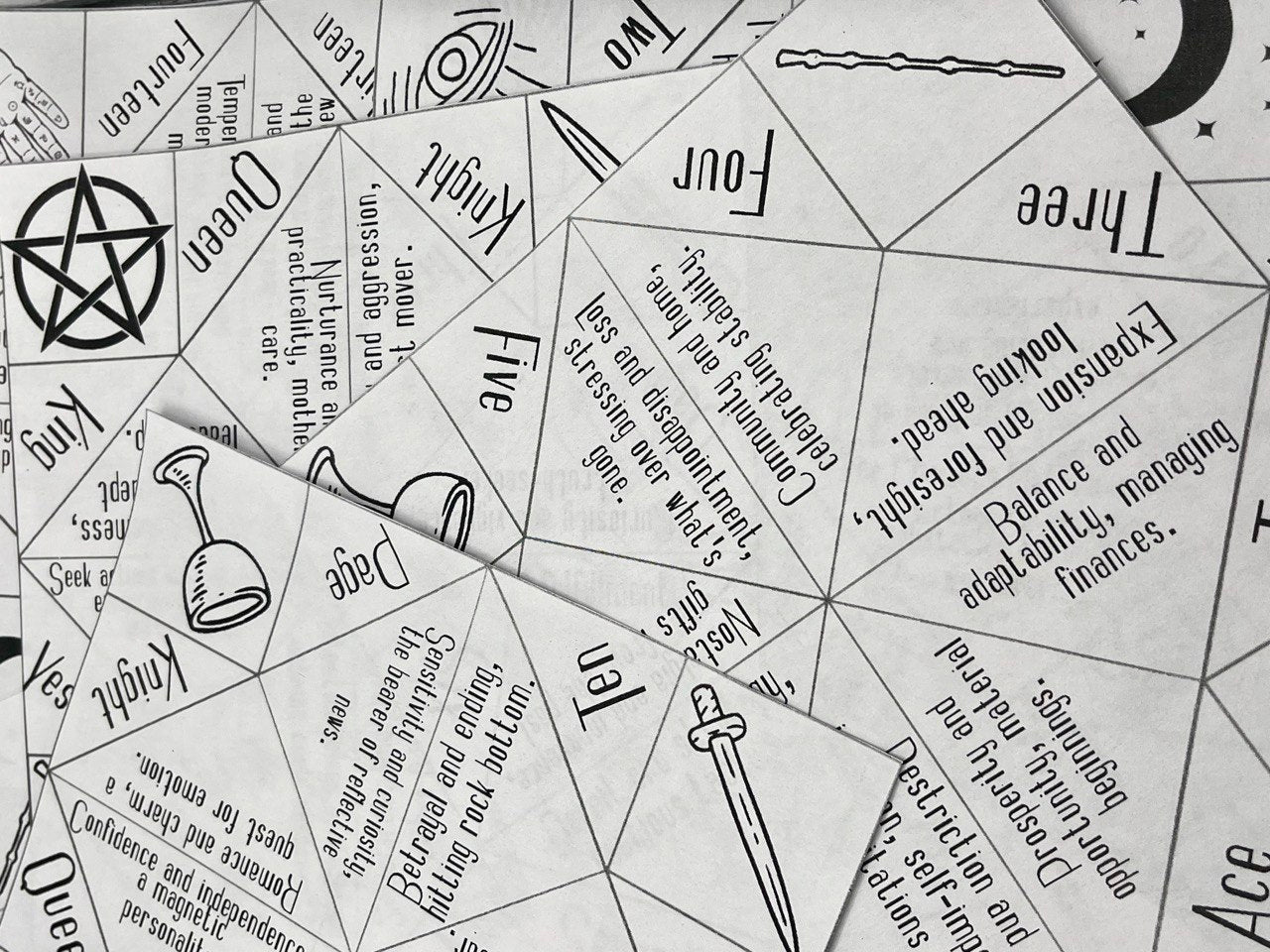 scattered origami sheets with tarot theme